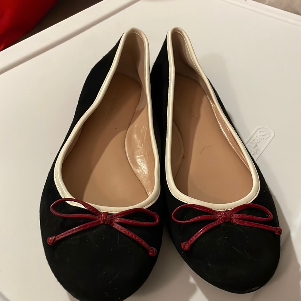 Black ballet flats with red bow